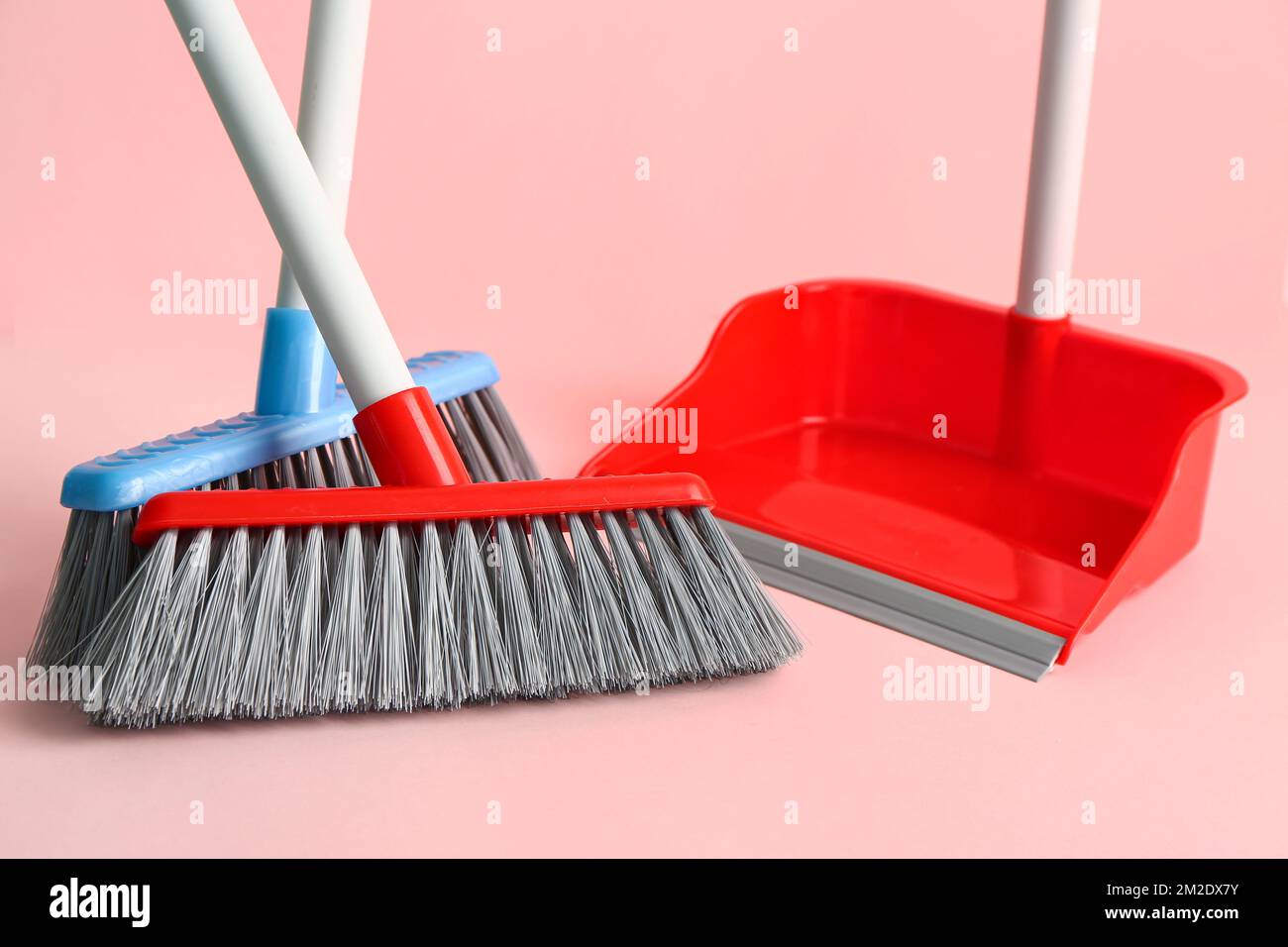 Cleaning brooms and dustpan on pink background, closeup Stock Photo Alamy