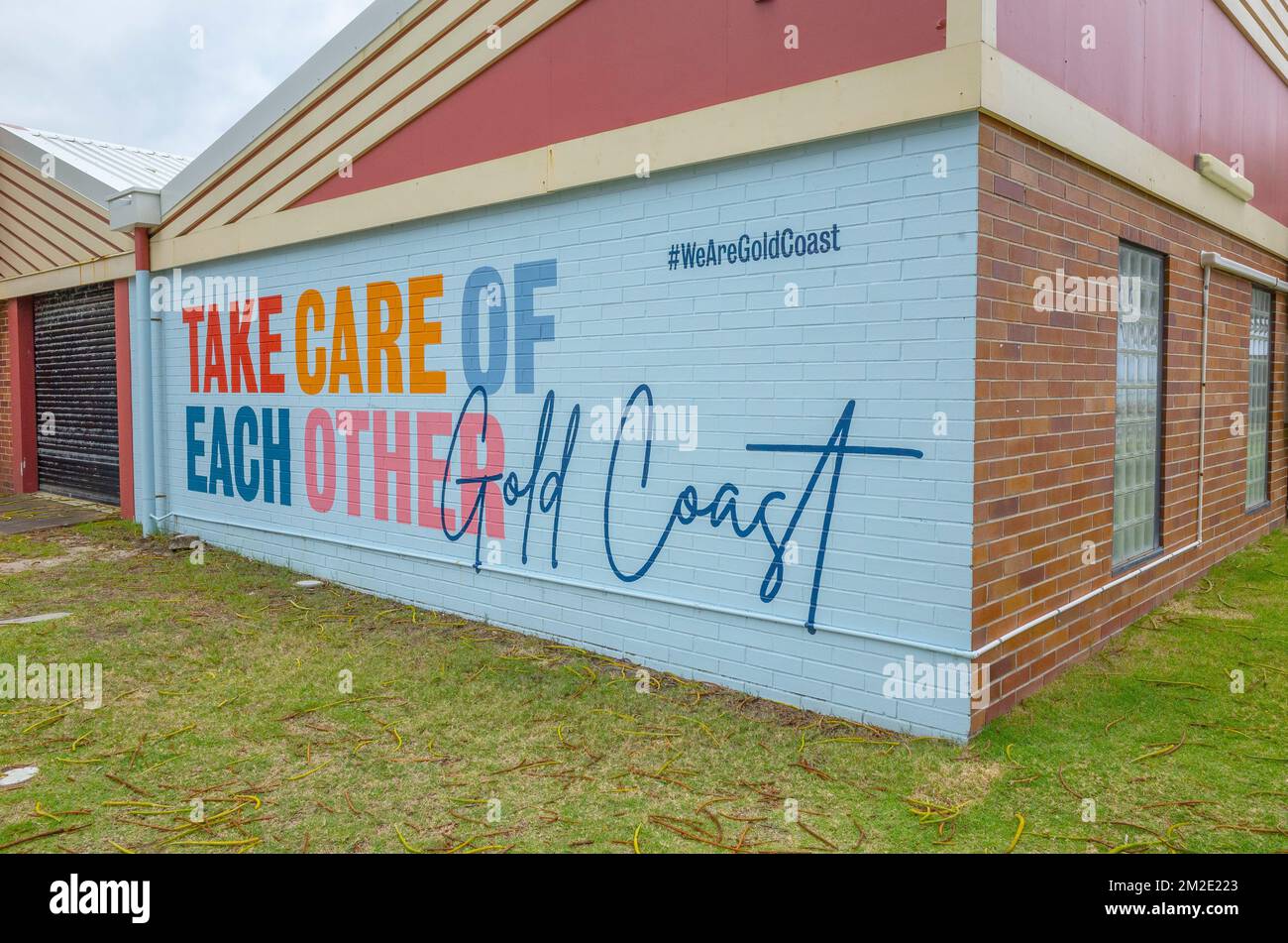 The John Cunningham Lifeguard Centre at Coolangatta, gold coast, queensland, australia with sign 'take care of each other' on the wall facing the road Stock Photo