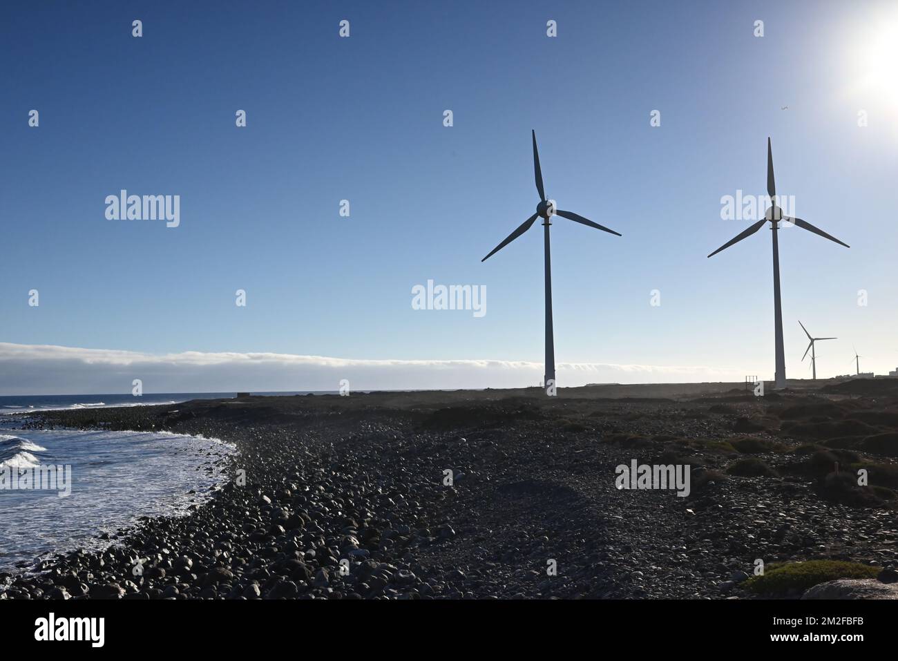 The wind turbines on a beach on a sunny day - the concept of renewable ...