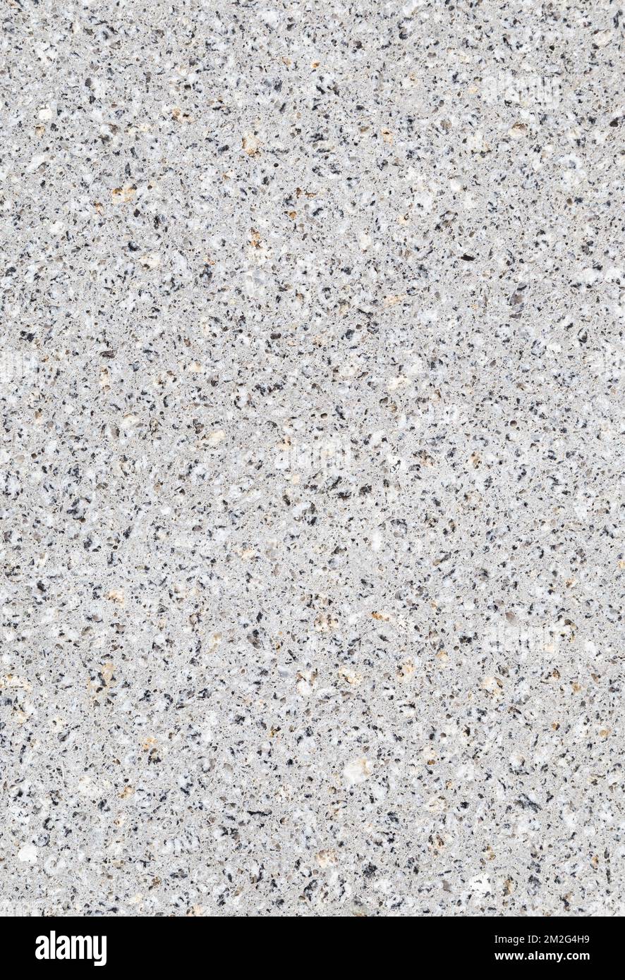Close-up of a wall or flooring made of concrete or cement and small stones. Abstract full frame textured background, copy space. Stock Photo