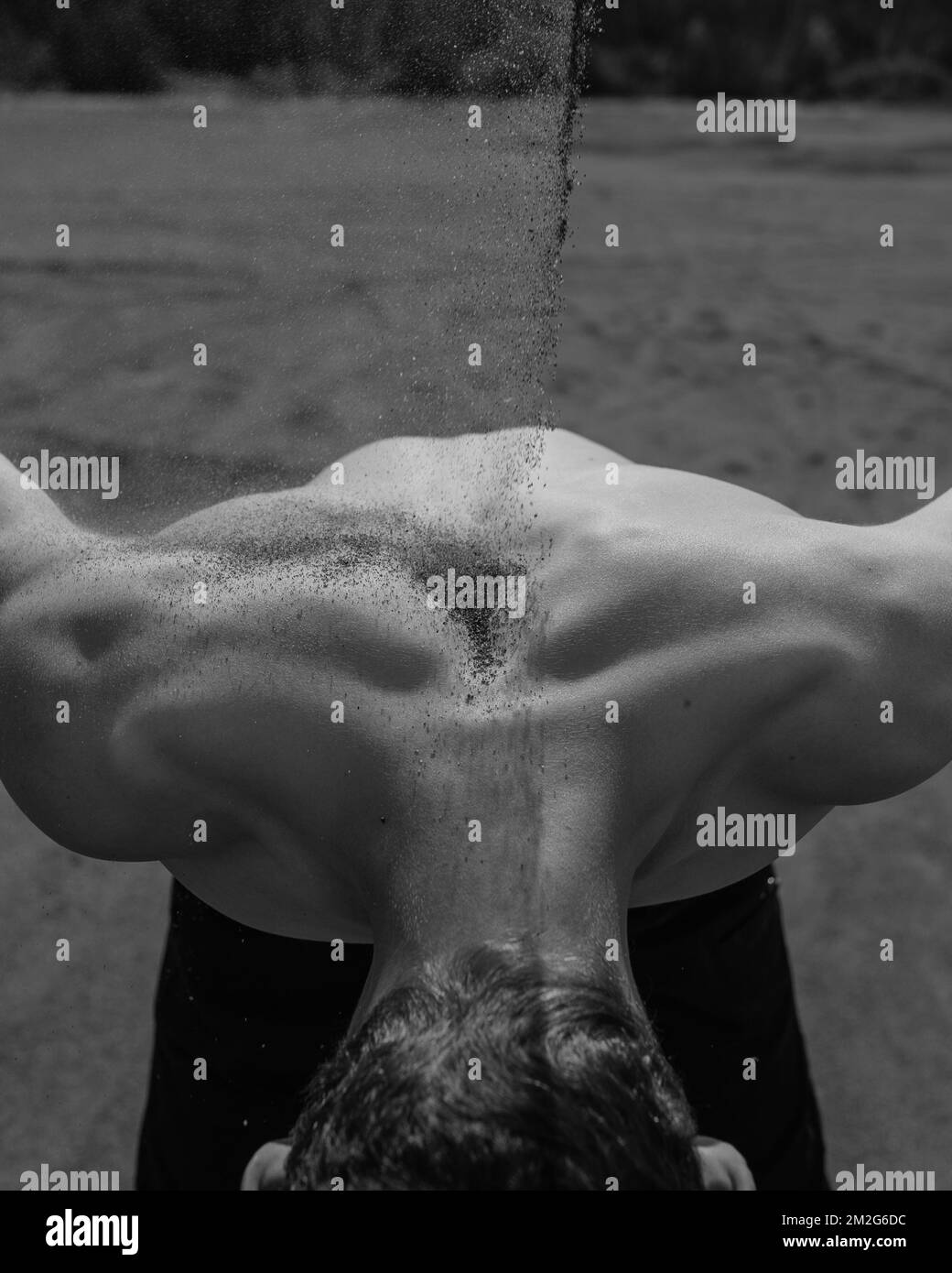 sand falls on the man's back Stock Photo