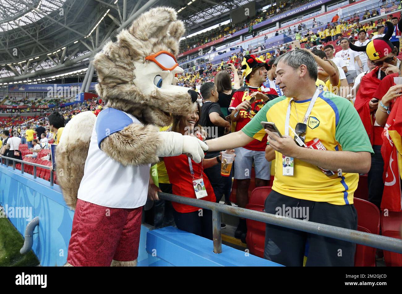 A World Cup fox mascot greets a Brazilian fan, ahead of a soccer game between Belgian national soccer team the Red Devils and Brazil in Kazan, Russia, Friday 06 July 2018, the quarter-finals of the 2018 FIFA World Cup. BELGA PHOTO BRUNO FAHY  Stock Photo