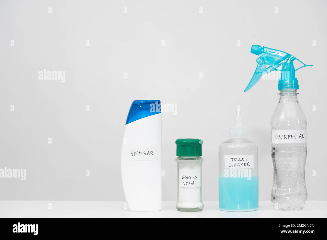 Home cleaning products with labels in reused plastic bottles. Recycled ...