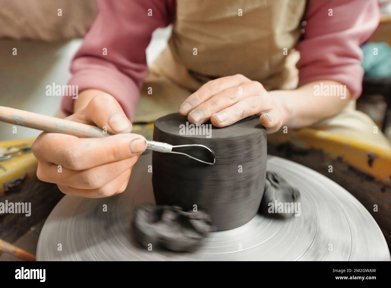 The master of sculpting pottery working in a studio. Shaping the clay