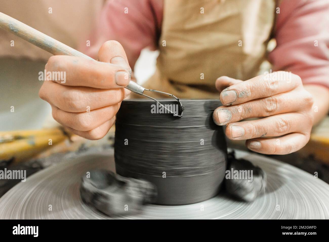 The master of sculpting pottery working in a studio. Shaping the clay