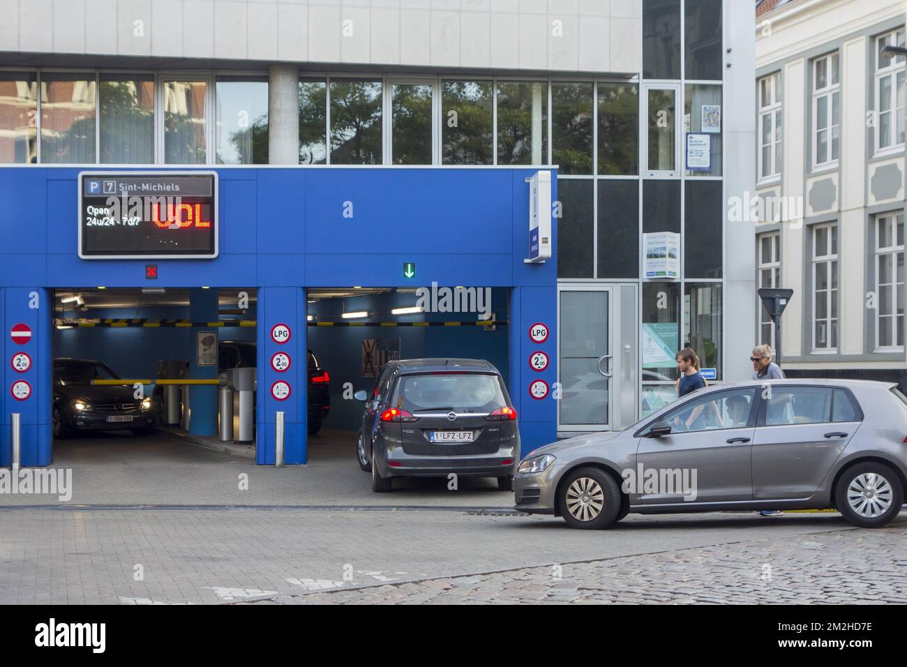 Cars still entering completely filled guarded underground car park in