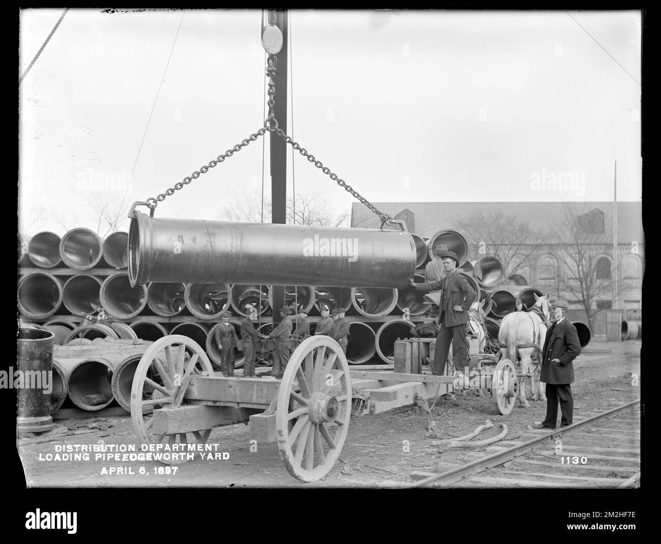 Distribution Department, Edgeworth Pipe Yard, loading 48inch pipe on a team, Malden, Mass., Apr