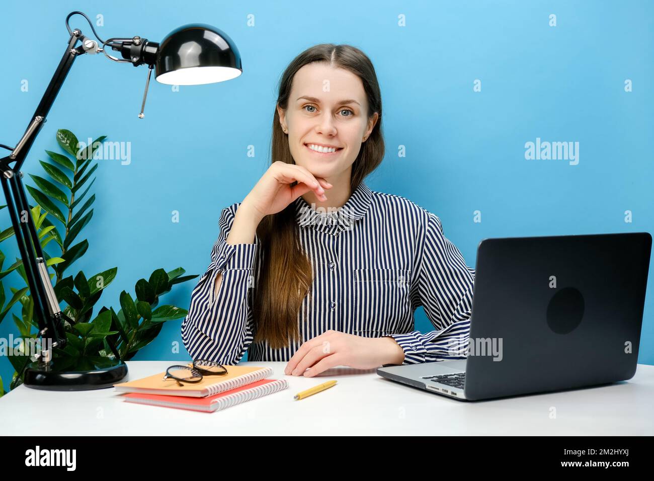 Portrait of successful smiling employee business woman sitting work at ...