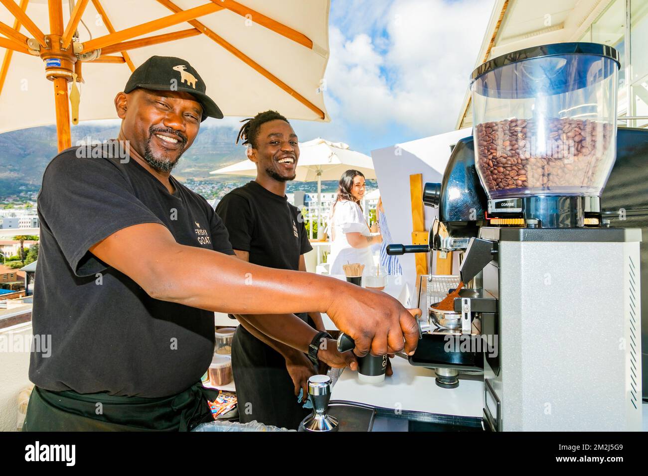 Cape Town, South Africa - November 15, 2022: African Male barista making a coffee at a cafe Stock Photo