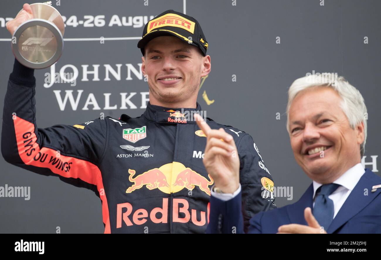 Winner Red Bull's Dutch driver Max Verstappen (L) is sprayed with champagne  by second plaved Mercedes' British driver Lewis Hamilton (R) during the  70th Anniversary Formula One Grand Prix at Silverstone Race