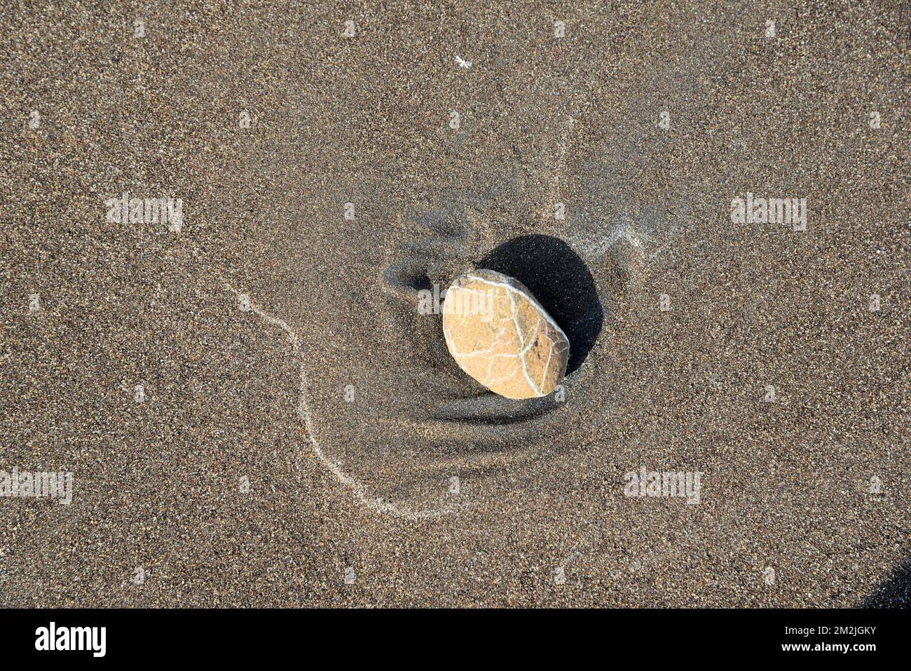 Rock stone on beach sand, Surwada Beach, Valsad, Gujarat, India Stock Photo