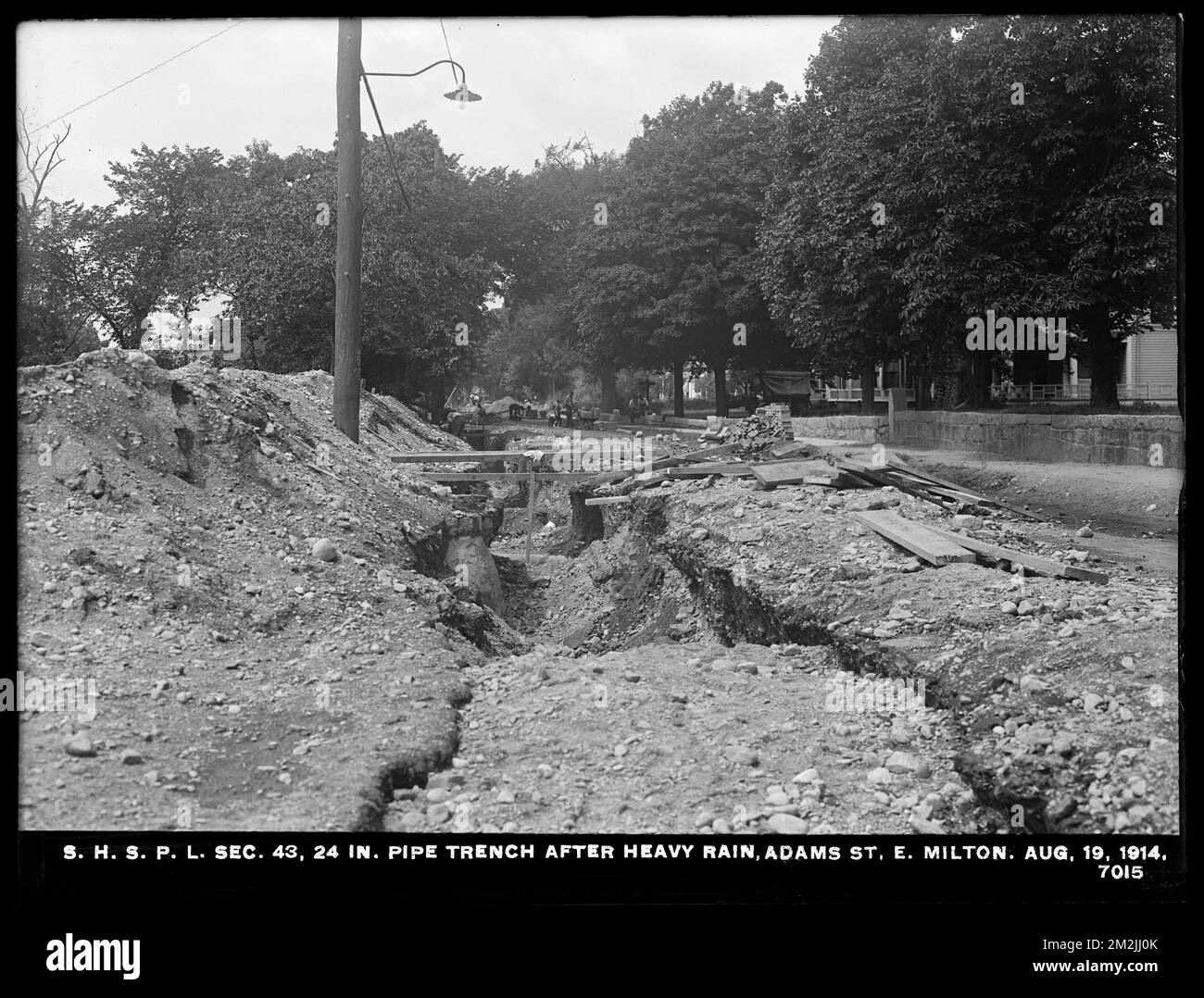 Distribution Department, Southern High Service Pipe Lines, Section 43, 24-inch pipe trench after heavy rain, Adams Street, East Milton, Milton, Mass., Aug. 19, 1914 , waterworks, pipes conduits, construction sites Stock Photo