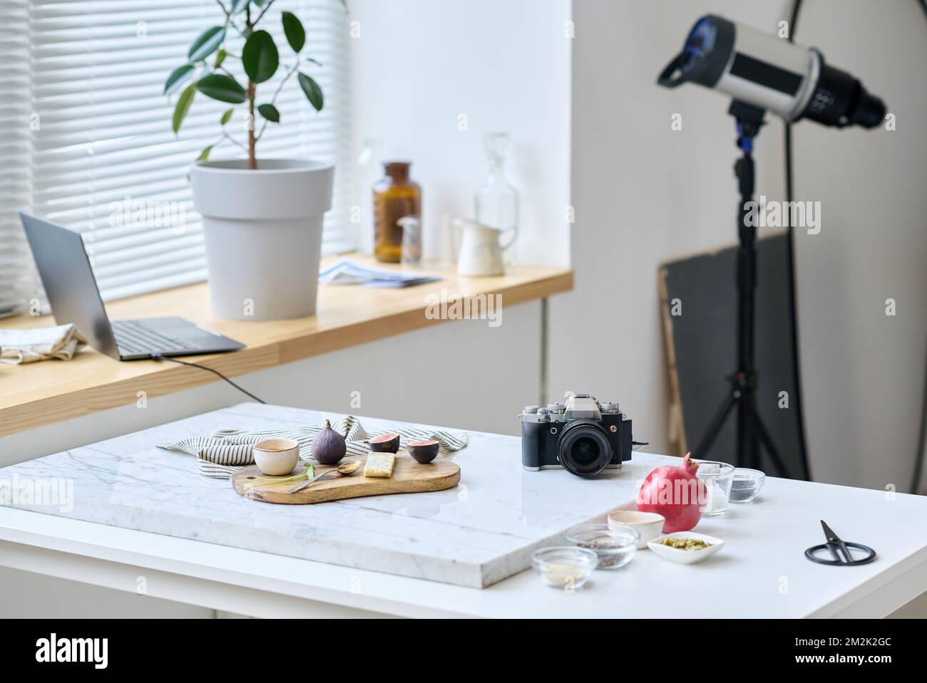 Horizontal image of photo studio with table preparing for taking pictures of still life with professional camera Stock Photo