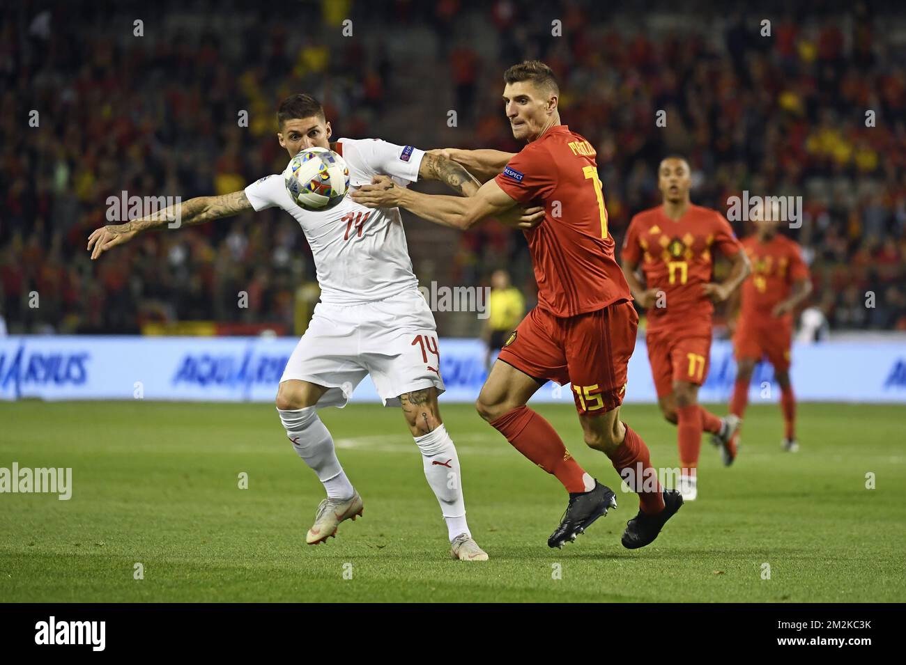Swiss Steven Zuber and Belgium's Thomas Meunier fight for the ball during a soccer game between Belgian national team the Red Devils and Switzerland in Brussels, Friday 12 October 2018, the second game in group 2 of the UEFA Nations League A competition. BELGA PHOTO DIRK WAEM  Stock Photo