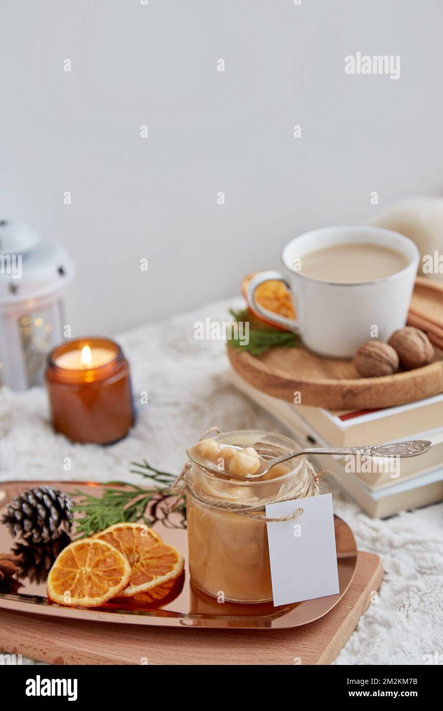 Homemade salted caramel in glass jar with mockup label among Christmas ...