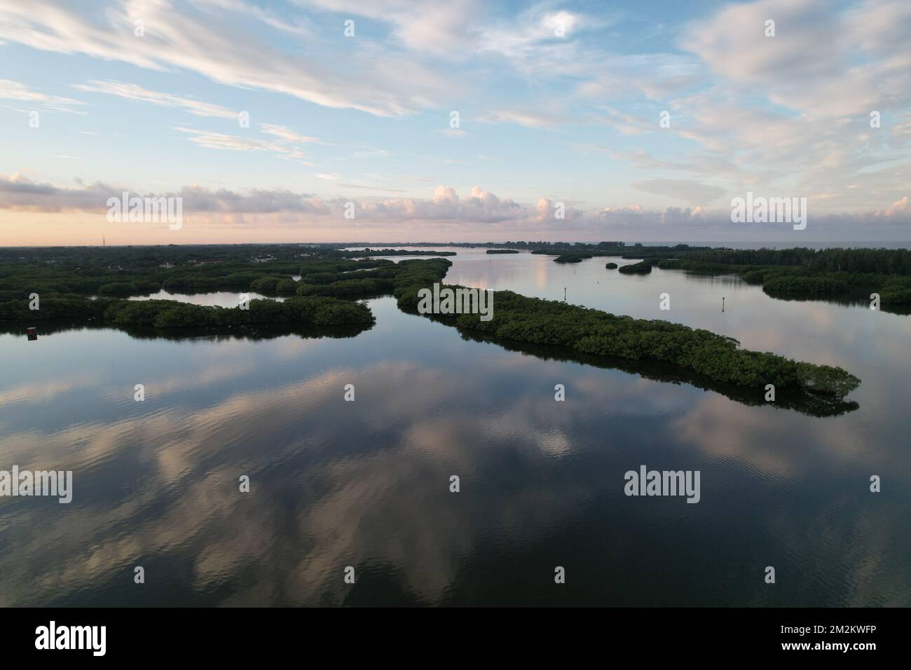 An aerial view of the lake reflecting the cloudy blue sky Stock Photo ...