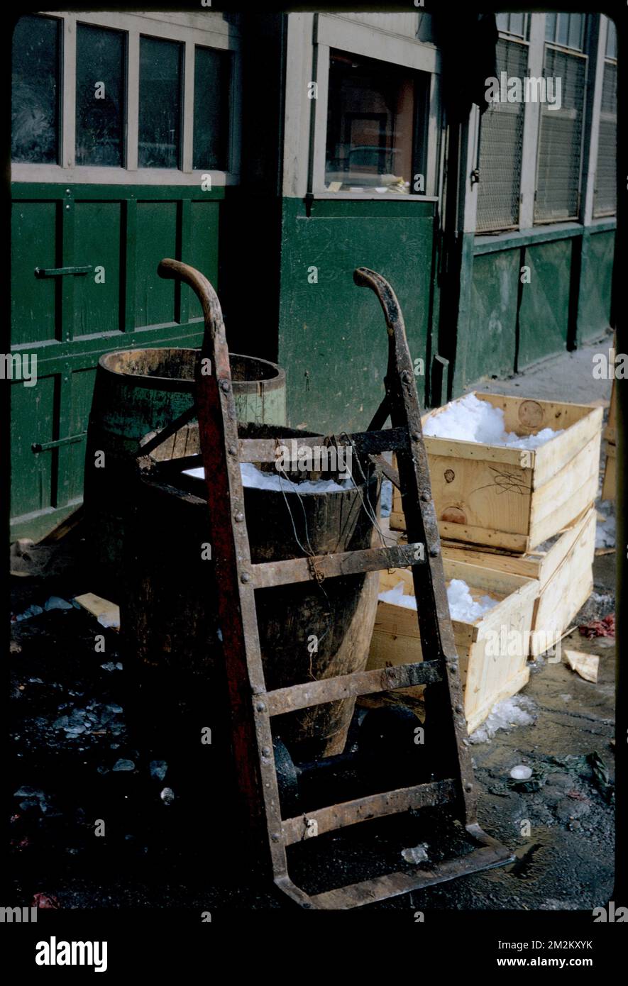 Dolly, barrels, and crates by exterior wall , Dollies Moving equipment