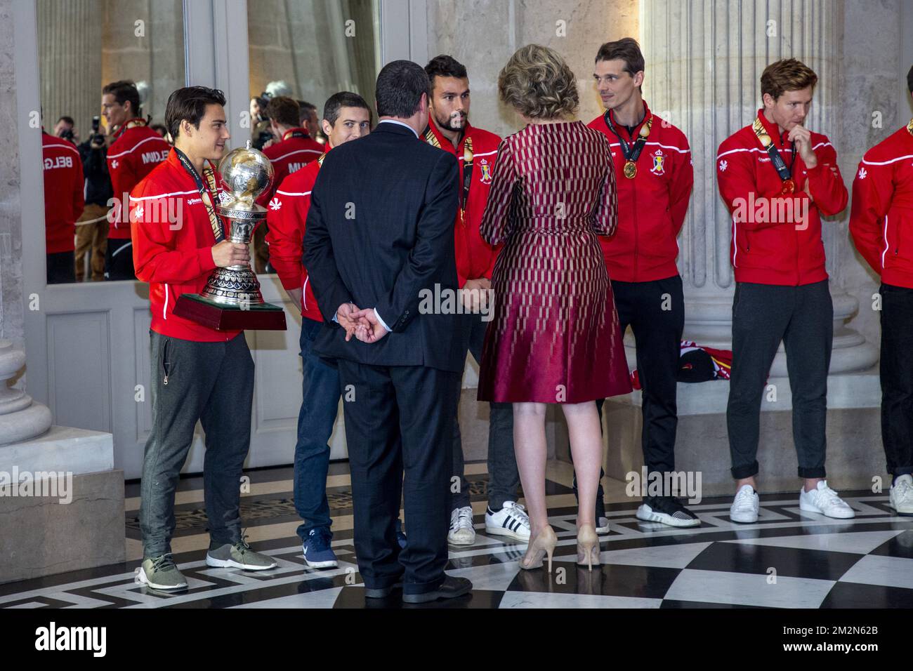 Belgium's captain Thomas Briels, holding the World Cup trophy, Belgium's John-John Dohmen, Belgium's Simon Gougnard, Belgium's Felix Denayer, Belgium's Tom Boon, Belgian Hockey Federation Secretary-General Serge Pilet and Queen Mathilde of Belgium a reception to honour the new hockey world champions, the Belgian Red Lions team, in the Royal castle in Laken - Laeken, Tuesday 18 December 2018. Red Lions won 3-2 the final against The Netherlands in India last last Sunday. BELGA PHOTO HATIM KAGHAT Stock Photo