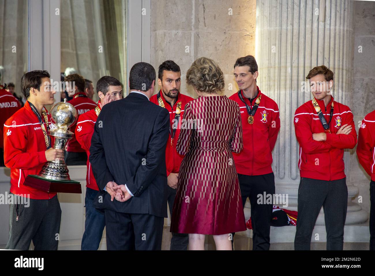 Belgium's captain Thomas Briels, holding the World Cup trophy, Belgium's John-John Dohmen, Belgium's Simon Gougnard, Belgium's Felix Denayer, Belgium's Tom Boon, Belgian Hockey Federation Secretary-General Serge Pilet and Queen Mathilde of Belgium a reception to honour the new hockey world champions, the Belgian Red Lions team, in the Royal castle in Laken - Laeken, Tuesday 18 December 2018. Red Lions won 3-2 the final against The Netherlands in India last last Sunday. BELGA PHOTO HATIM KAGHAT Stock Photo