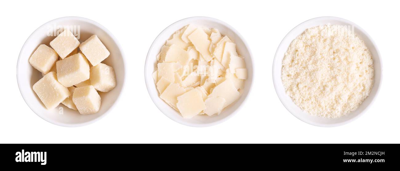 Grana Padano cheese, chunks, flakes and grated, in white bowls. Italian hard cheese, similar to Parmesan, with savory flavor and crumbly texture. Stock Photo