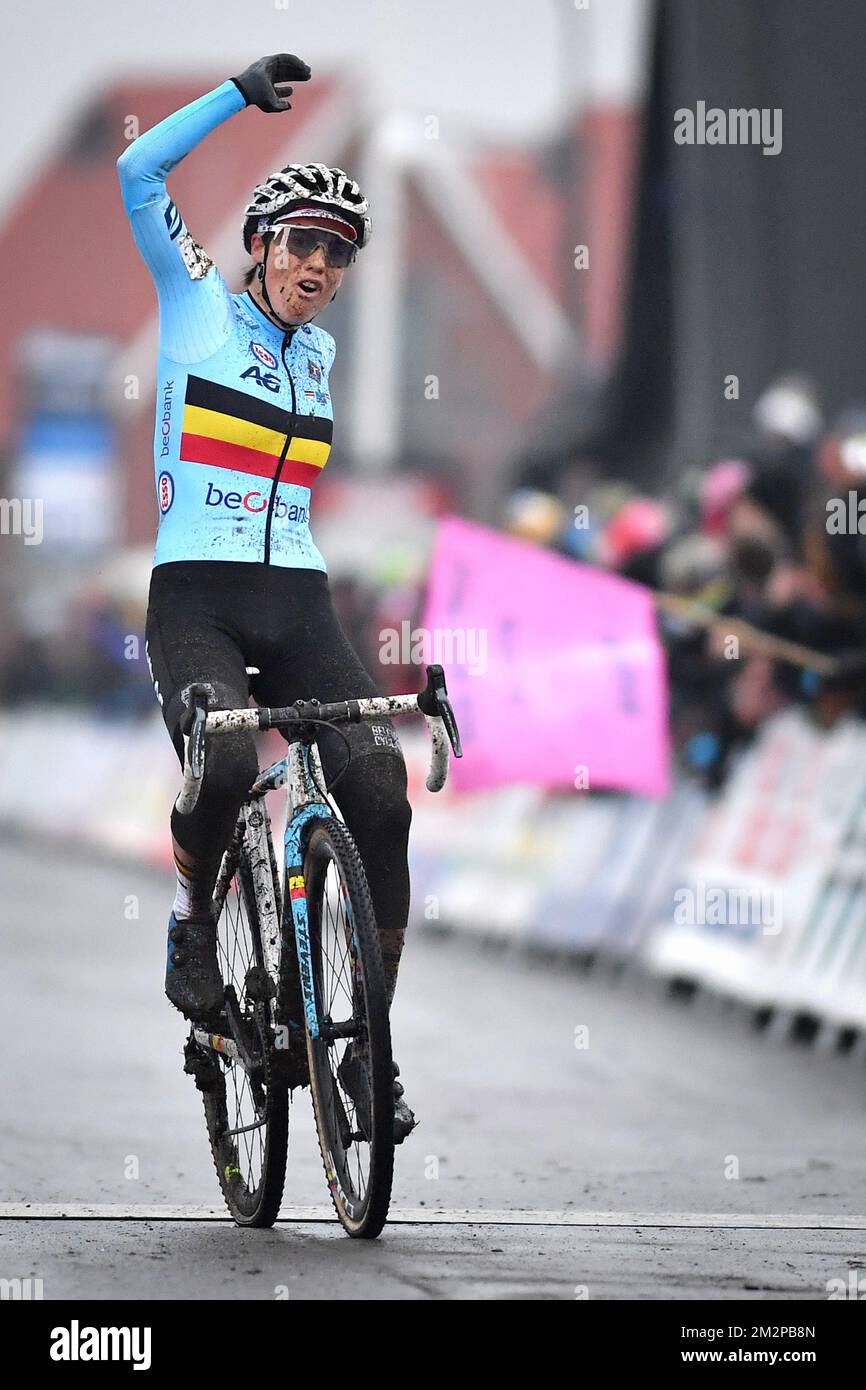 Belgian Sanne Cant celebrates as she crosses the finish line to
