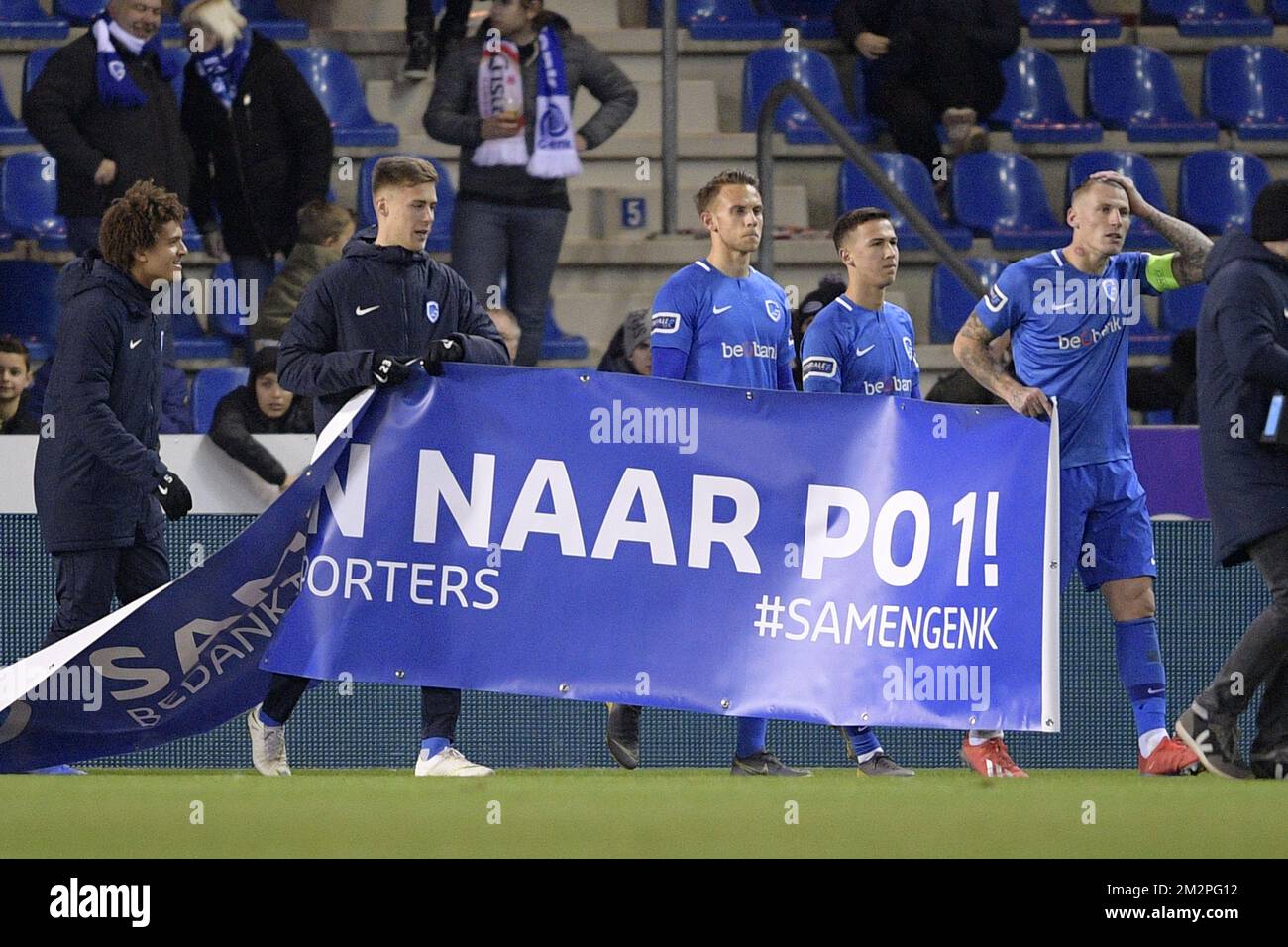 Genk's players pictured with a banner after a soccer match between KRC