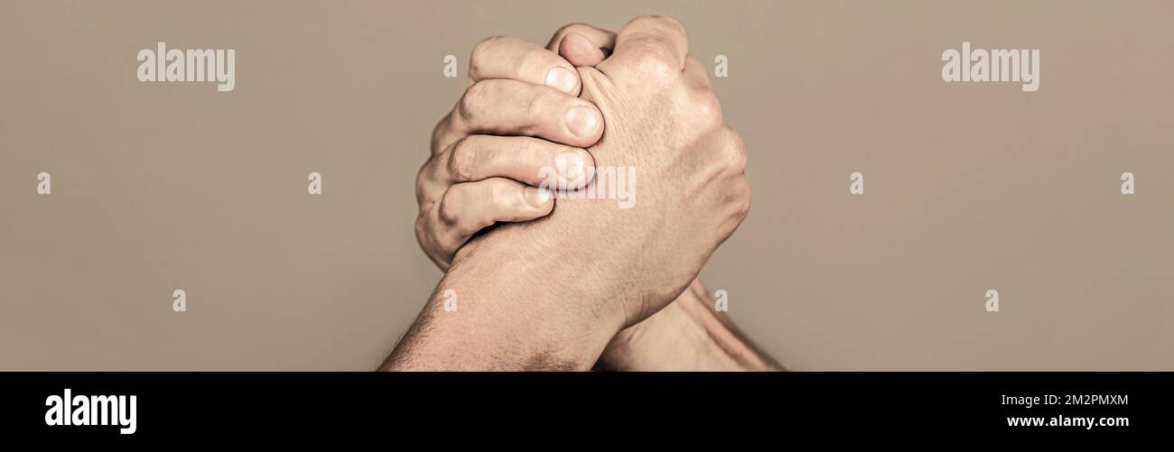 Two men arm wrestling. Arms wrestling. Handshake, arms, friendship. Hand rivalry vs challenge