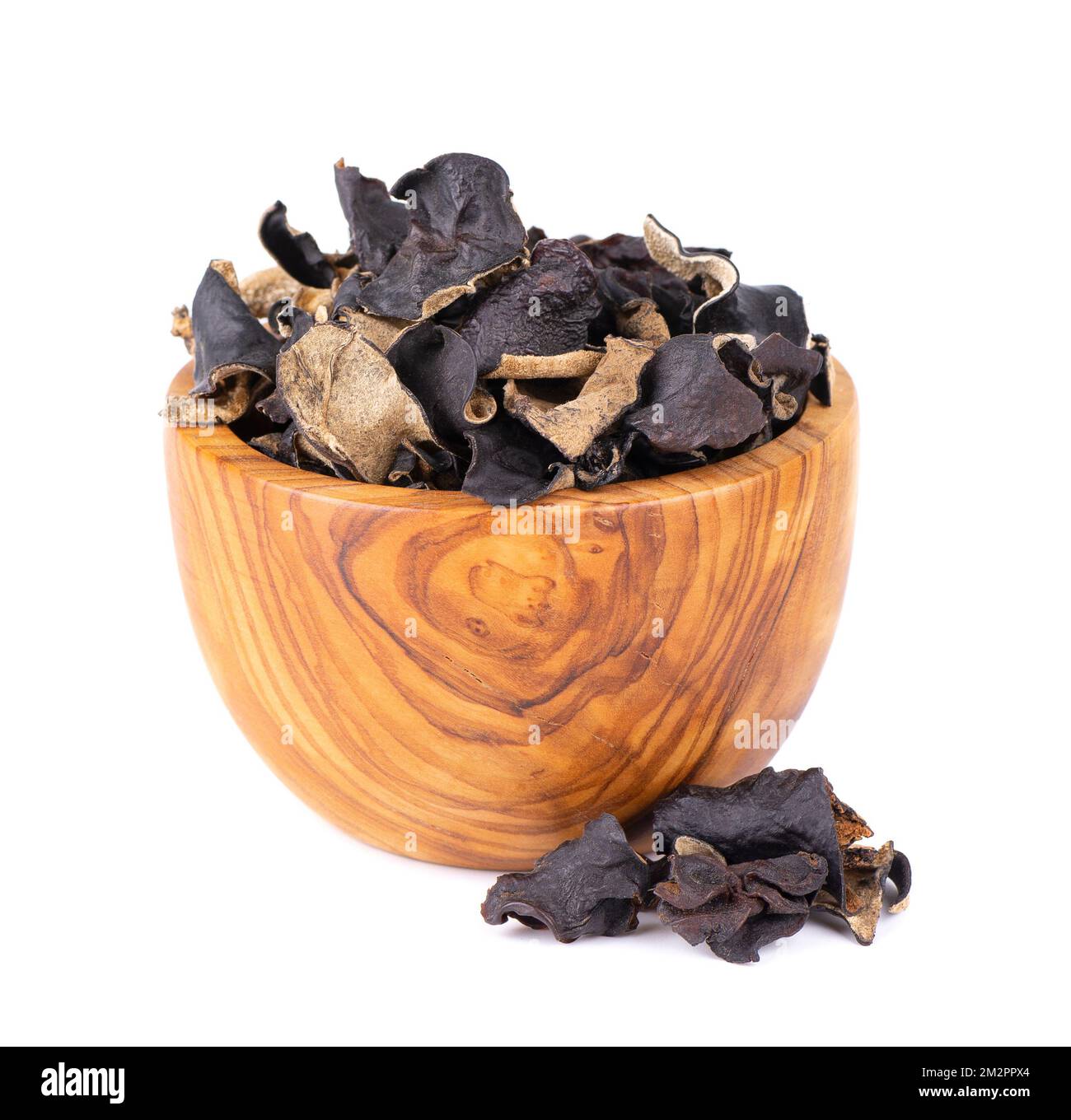 Dry black fungus in wooden bowl, isolated on white background. Chinese
