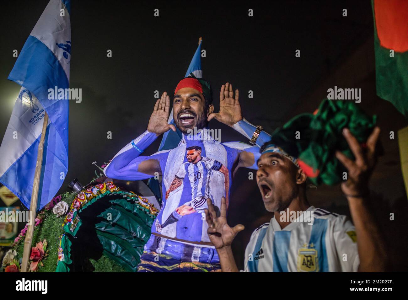 Dhaka, Bangladesh. 14th Dec, 2022. An Argentina soccer fan seen with paint on his body watches the live stream match between Argentina and Croatia at the World Cup. The Argentinian team, led by Messi, beat Croatia 3-0, qualifying for the finals, for the first time since 2014. (Photo by Sazzad Hossain/SOPA Images/Sipa USA) Credit: Sipa USA/Alamy Live News Stock Photo