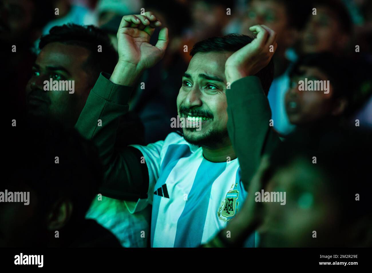 Dhaka, Bangladesh. 14th Dec, 2022. Football fans react as they watch the Qatar 2022 World Cup football match between Argentina and Croatia on a big screen at the Dhaka. The Argentinian team, led by Messi, beat Croatia 3-0, qualifying for the finals, for the first time since 2014. (Photo by Sazzad Hossain/SOPA Images/Sipa USA) Credit: Sipa USA/Alamy Live News Stock Photo