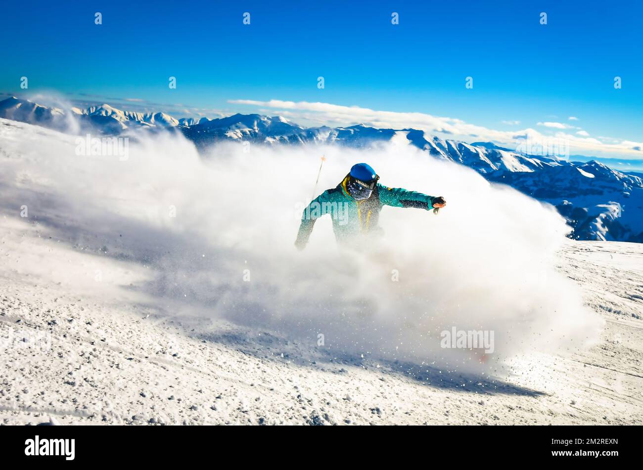 Professional skier at full speed ski downhill on fresh snow do carving