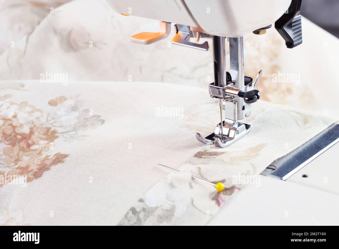 Modern sewing machine presser foot and colofrul cloth. Sewing process