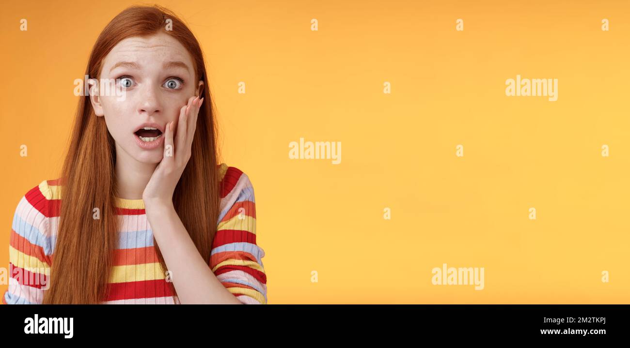 Concerned worried ginger girl blue eyes drop jaw gasping touch cheek