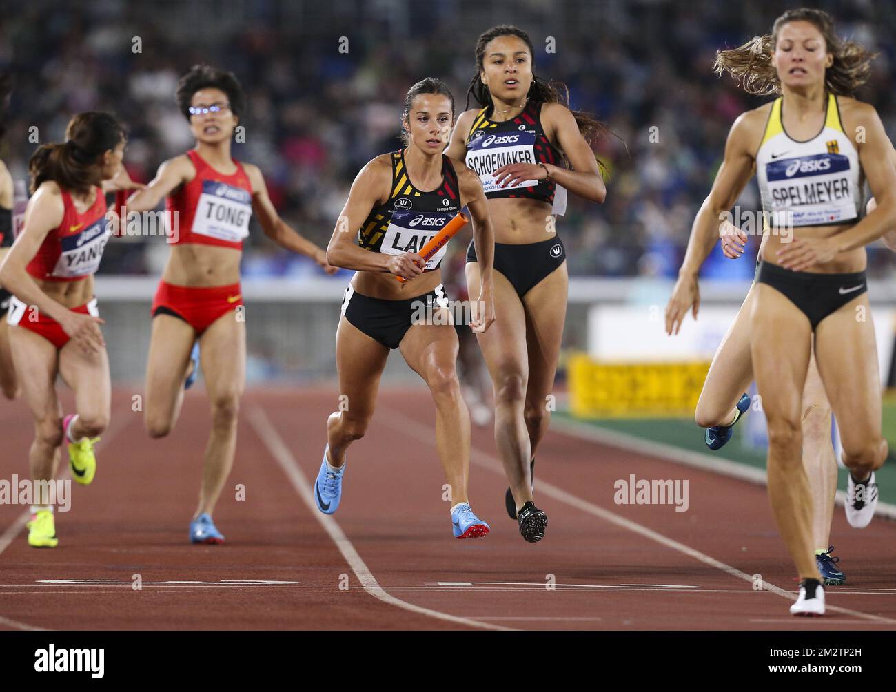 Camille Laus of Belgium receives the baton from teammate Liefde Schoemaker  during the women 4x400m B-final at the IAAF World Relays athletics event at  Nissan Stadium in Yokohama, Japan, Sunday 12 May