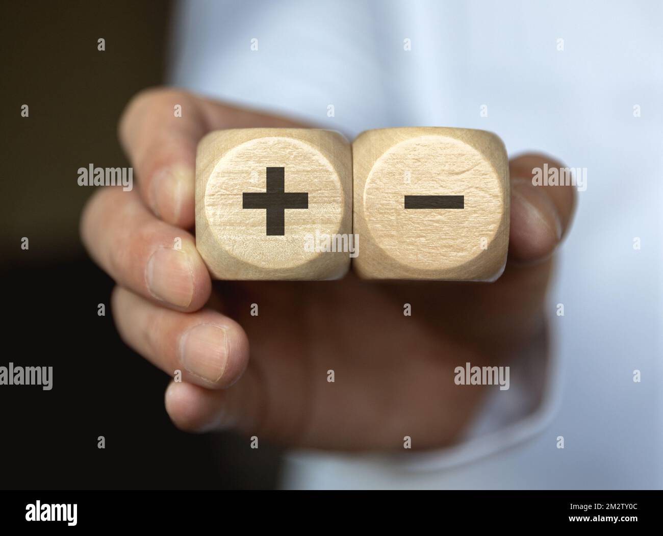 The concept of choosing one of the blocks engraved with plus and minus Stock Photo