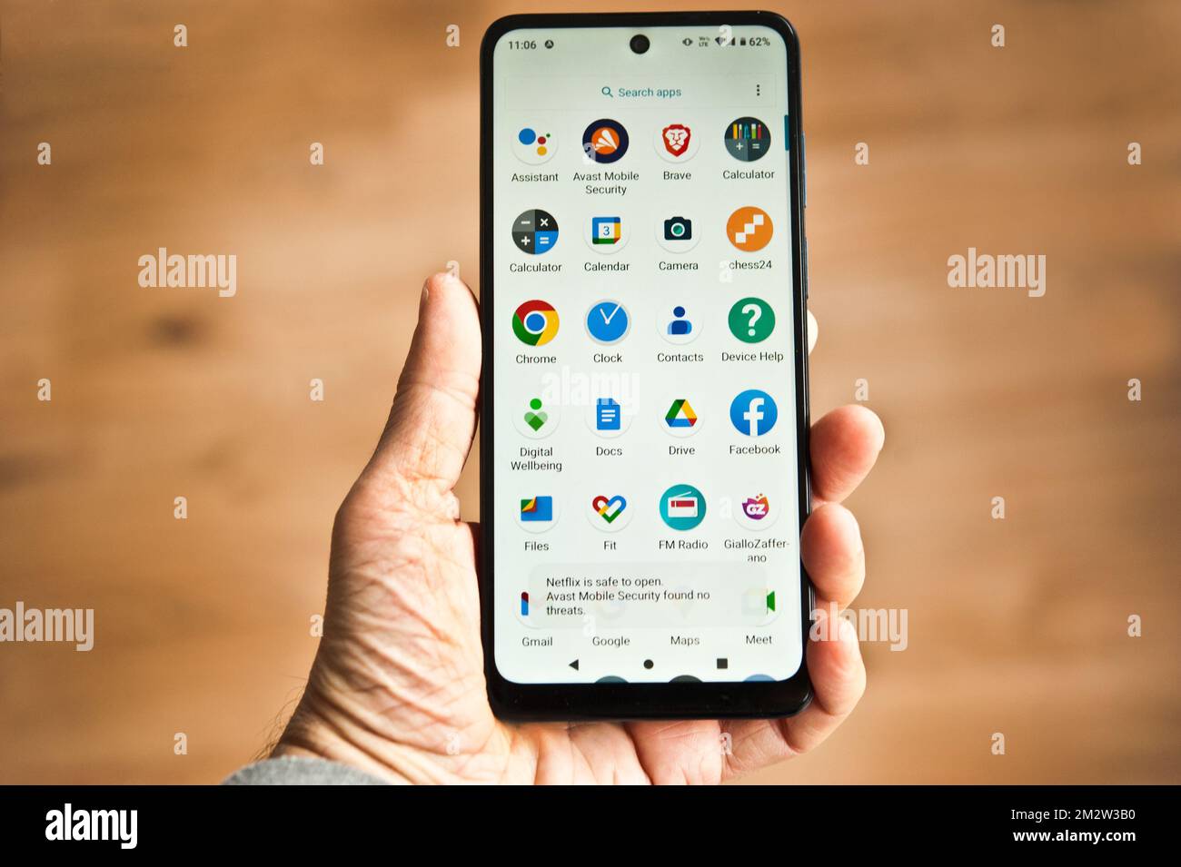 hand holding a smartphone with icons on screen Stock Photo - Alamy