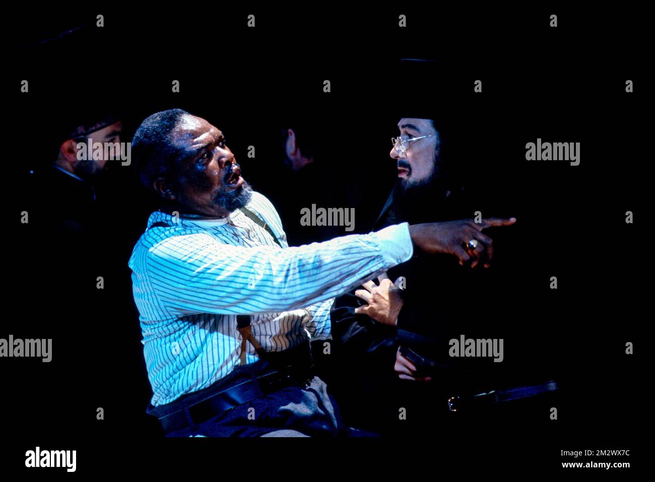 dying from poisoned mushrooms - l-r: Willard White (Boris Timofeyevich Ismailov), Arwel Huw Morgan (Priest) in LADY MACBETH OF MTSENSK at English National Opera (ENO), London Coliseum, London WC2  06/06/1991  music: Dmitri Shostakovich  libretto: Alexander Preys & Dmitri Shostakovich  conductor: Mark Elder  design: Stefanos Lazaridis  lighting: Paul Pyant  choreography: Quinny Sacks  director: David Pountney Stock Photo