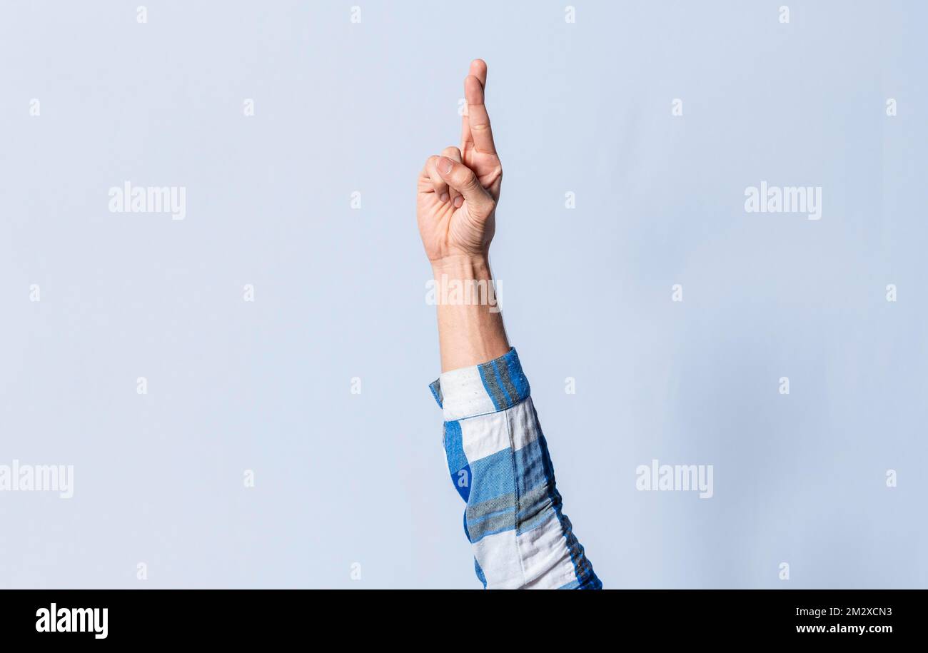Hand gesturing the letter R in sign language on an isolated background ...
