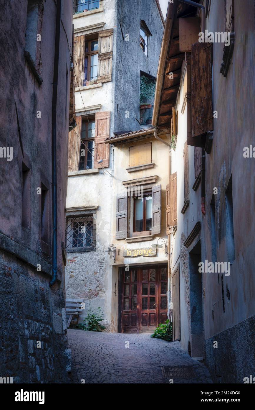 A narrow cobblestone street and hidden restaurant in Asolo, Italy. Stock Photo