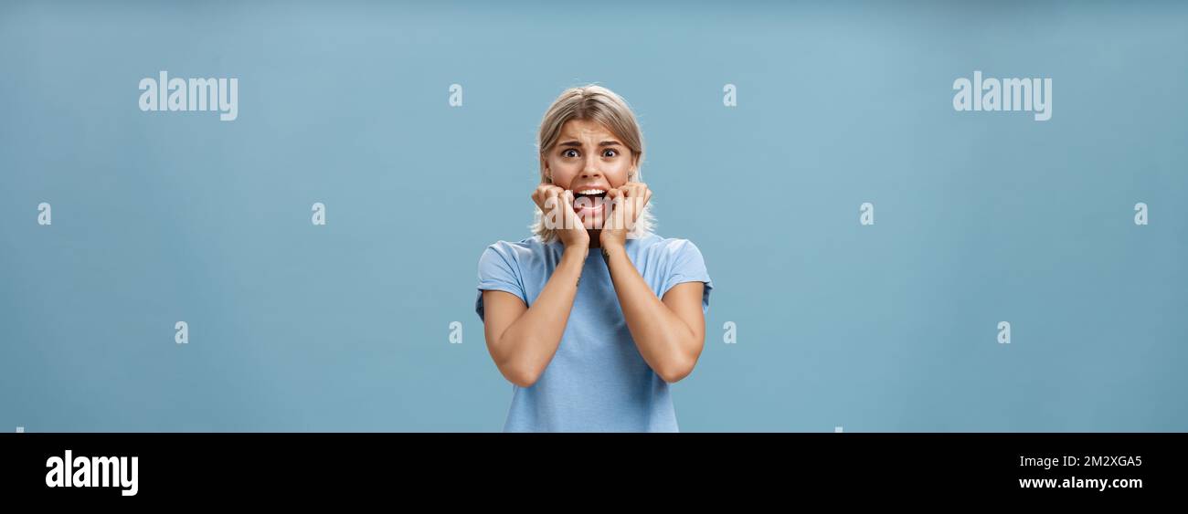 Indoor shot of shocked troubled girlfriend hearing mom returned home ...