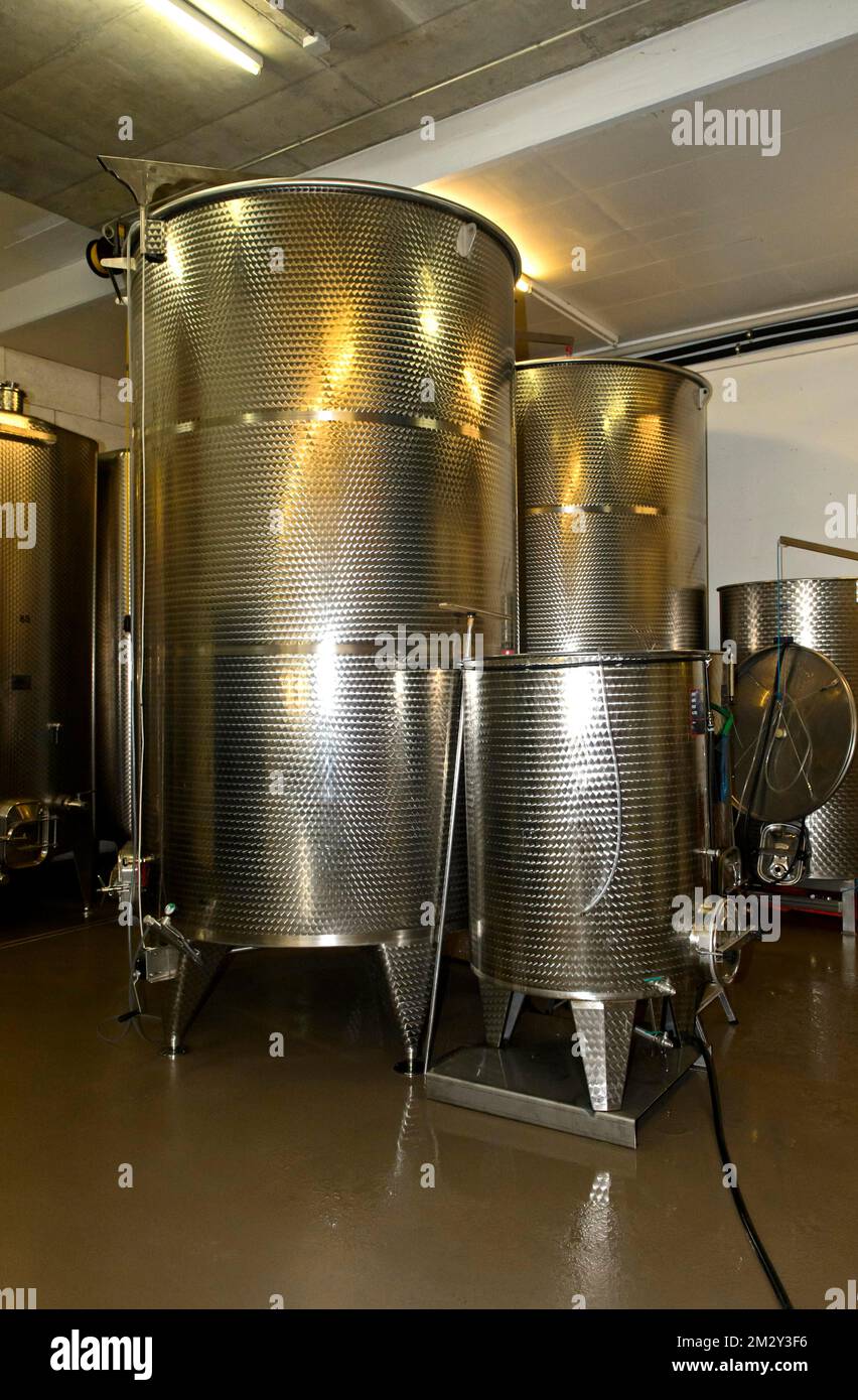 Stainless steel tanks for the fermentation of wine in the St Jodern winery, Heidi village Visperterminen, Valais, Switzerland Stock Photo