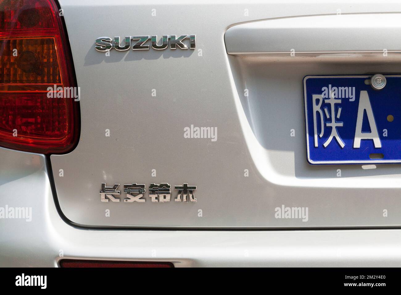 Older Suzuki car rear with section of numberplate and model written in Chinese characters / writing model name of vehicle in China. Xian, China. (125) Stock Photo
