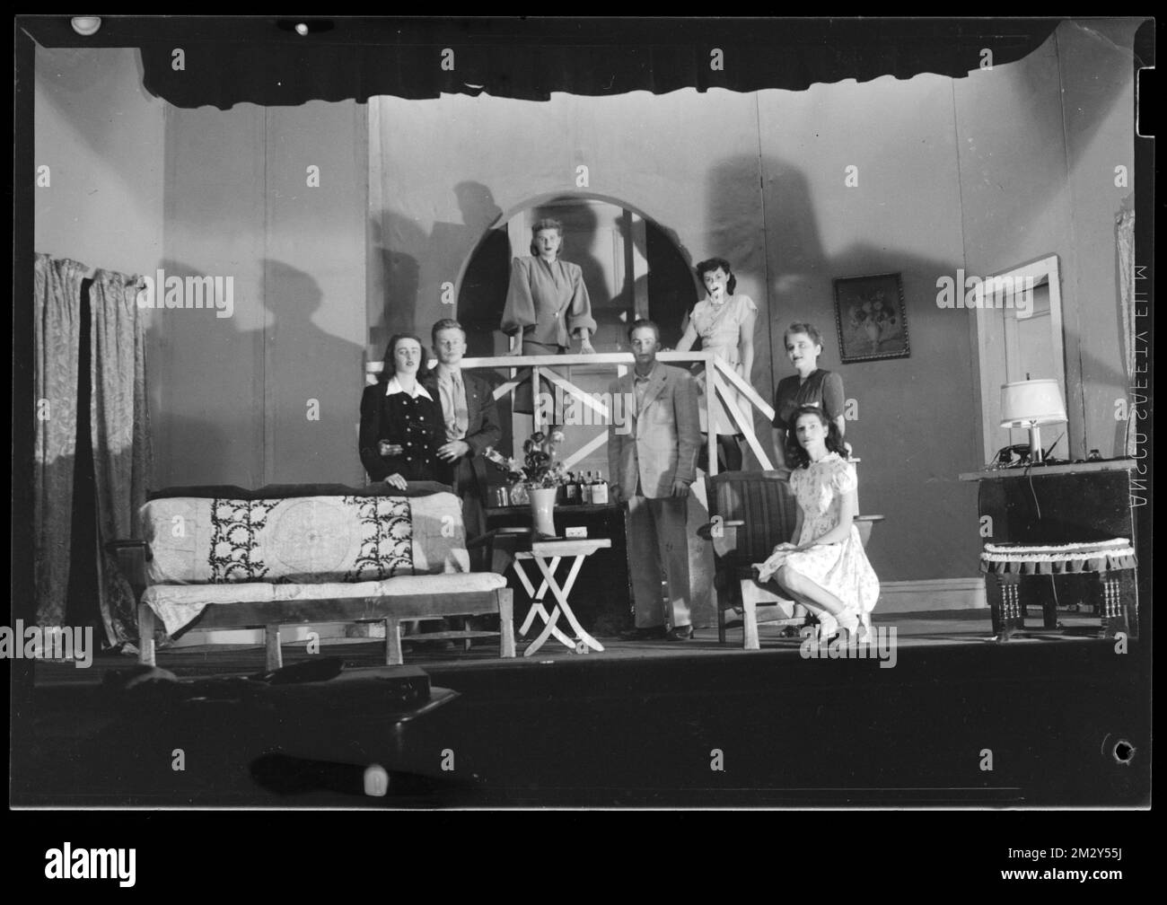 Five women and two men pose on a set , Sets Architectural elements