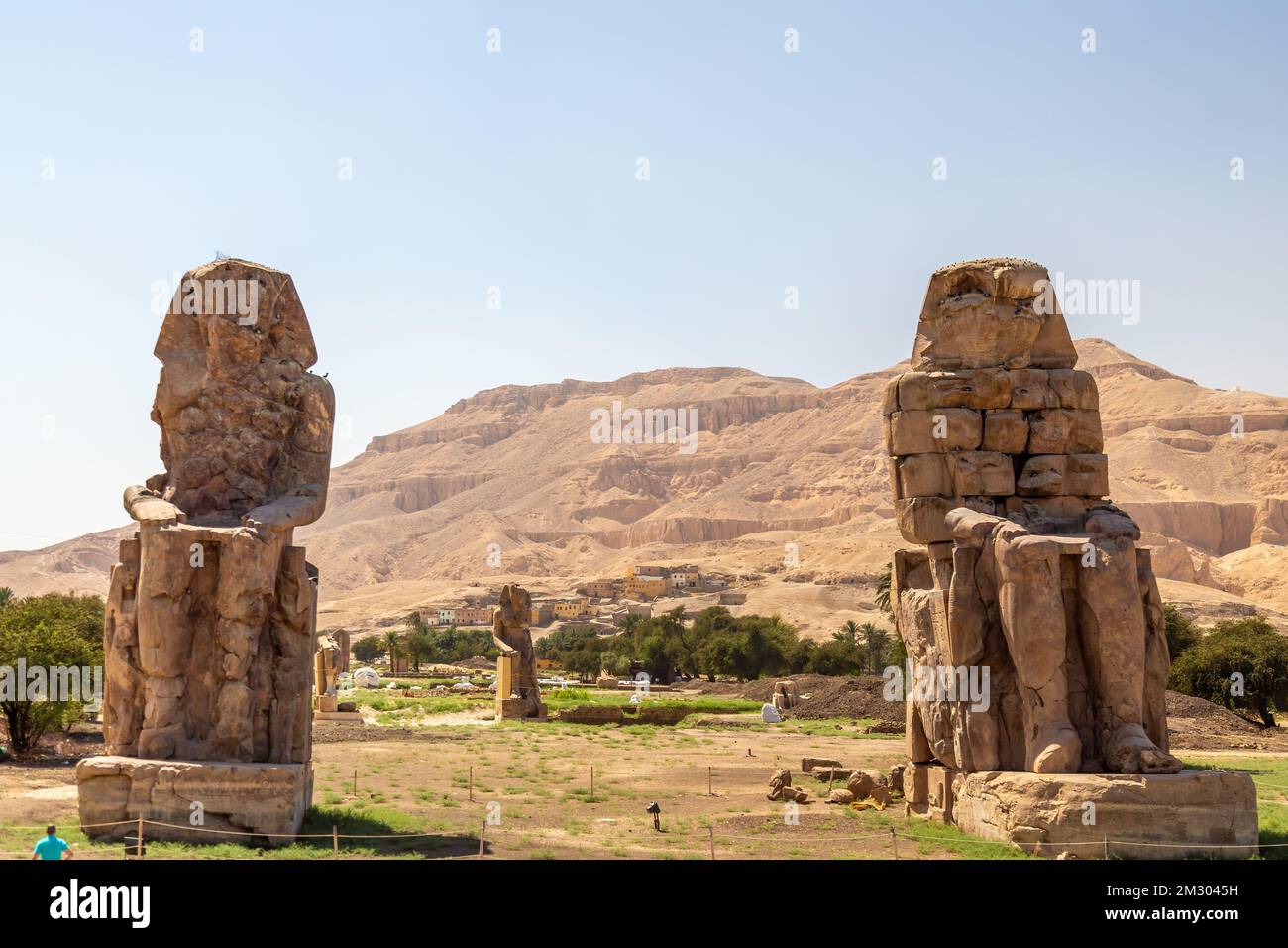View of Colossi of Memnon, stone statues of Pharaoh Amenhotep III, in Theban Necropolis, located west of the River Nile from Luxor, Egypt Stock Photo