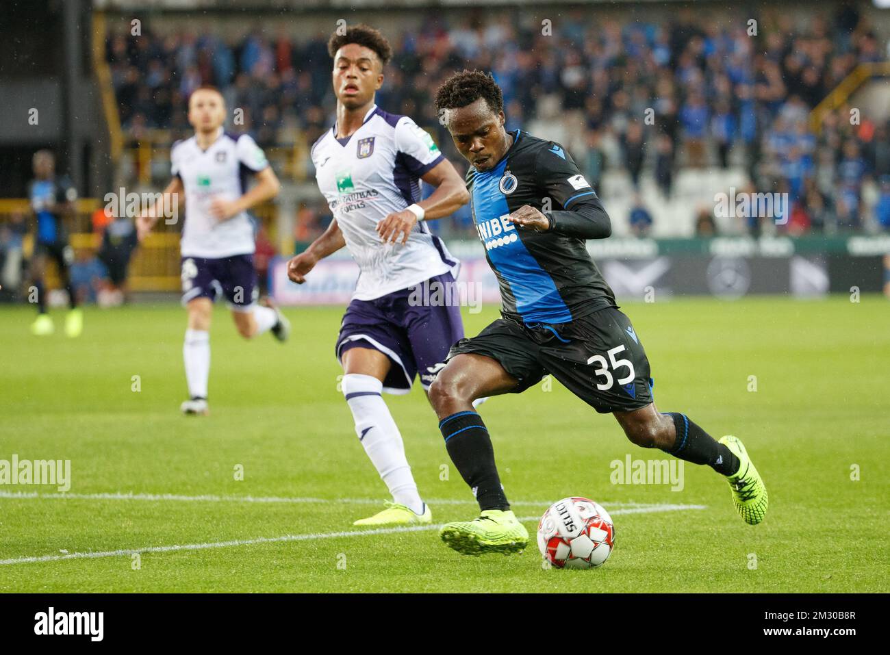 Club's Percy Tau and Anderlecht's Derrick Luckassen fight for the