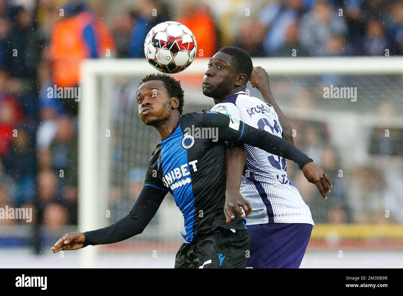 Club's Percy Tau and Anderlecht's Derrick Luckassen fight for the