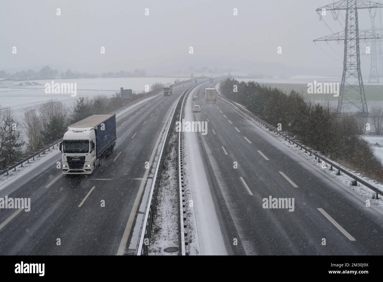 Coburg, Germany. 14 December 2022. Snow falling on the A73 near Coburg this afternoon. Bad weather with snow and ice has made travelling more difficult today throughout Bavaria. The German weather service has issued a warning of dangerous conditions on the road and possible disruptions to rail travel. Stock Photo