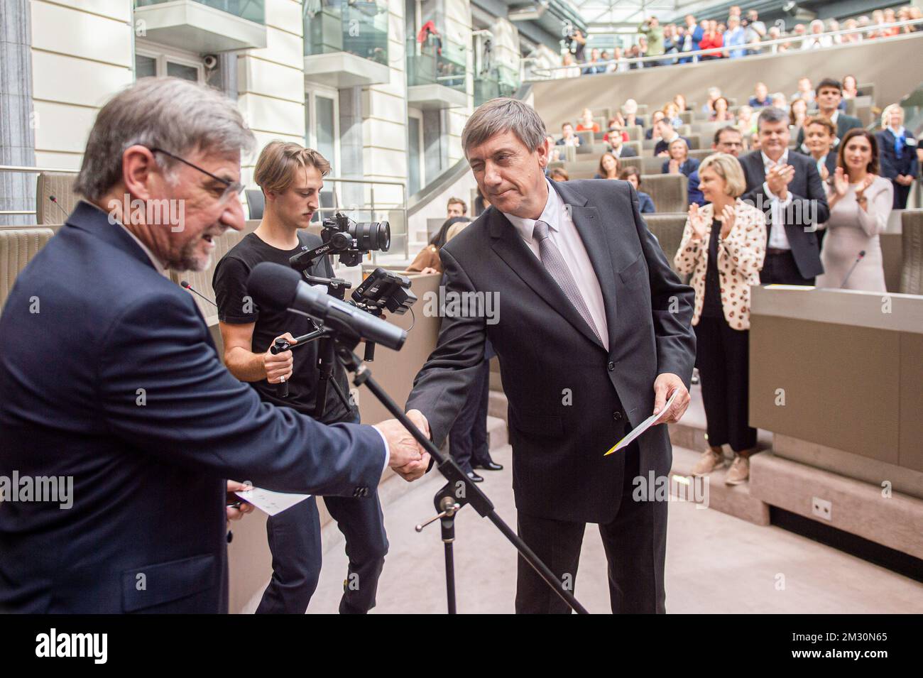 Flemish parliament chairman Wilfried Vandaele and Flemish Minister President N-VA Jan Jambon shake hands during the oath taking ceremony at the start of a plenary session of the Flemish Parliament in Brussels, Wednesday 02 October 2019. The newly formed Flemish government presents its government declaration to the Flemish Parliament. BELGA PHOTO JONAS ROOSENS  Stock Photo