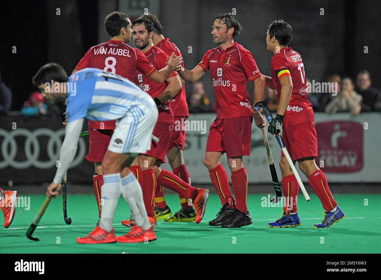 Belgian team celebrates after scoring a friendly hockey game between
