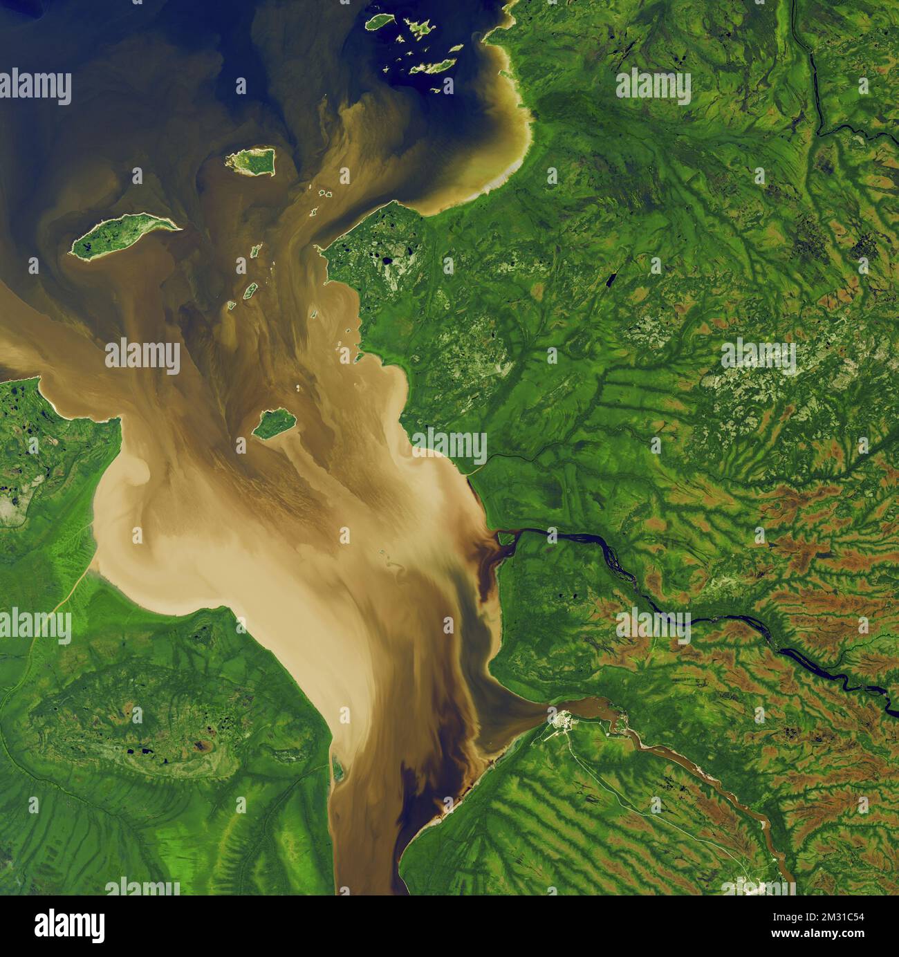 Rupert Bay, an arm of James Bay, extends into Quebec, Canada. Many rivers carry sediment into the bay and combine with seawater coming in from the tide. A prominent sediment stream extends past Stag Island and a vortex curls off Stag Rock in the middle of the bay. Sediment trails off the islands toward the mainland, indicating the tide was coming in at the time of image acquisition on 30 July 2016. An optimised version of a Landsat 8 / USGS. Credit: NASA/USGS Stock Photo